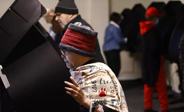 Voters cast their ballots during the first day of in person early voting at the Franklin County Board of Elections in Columbus, Ohio, Tuesday, Oct. 8, 2024. (AP Photo/Paul Vernon)