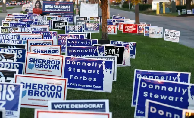 Campaign signs are posted outside of the Franklin County Board of Elections in Columbus, Ohio, Tuesday, Oct. 8, 2024. (AP Photo/Paul Vernon)