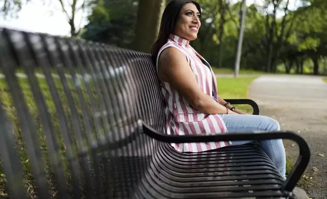 Julieth Luna Garcia, a transgender woman from El Salvador, sits on a bench as she looks at trees at Horner Park in Chicago, Monday, Sept. 30, 2024. (AP Photo/Nam Y. Huh)