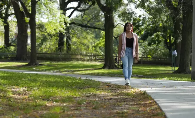 Julieth Luna Garcia, a transgender woman from El Salvador, takes a walk at Horner Park in Chicago, Monday, Sept. 30, 2024. (AP Photo/Nam Y. Huh)