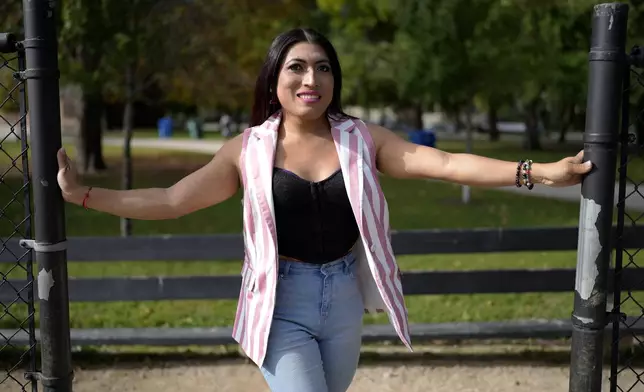 Julieth Luna Garcia, a transgender woman from El Salvador, poses for photos at Horner Park in Chicago, Monday, Sept. 30, 2024. (AP Photo/Nam Y. Huh)