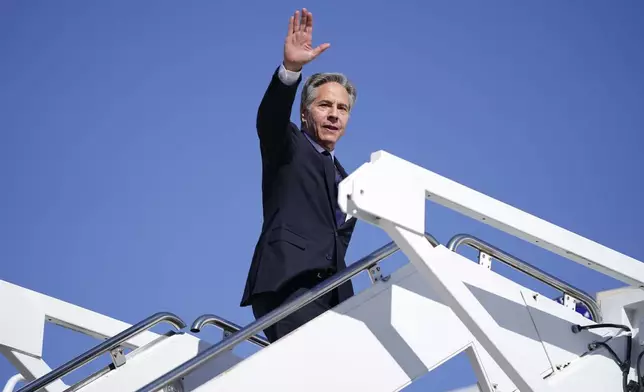 Secretary of State Antony Blinken waves as he boards a plane en route to the Middle East as he departs Joint Base Andrews, Md., Monday, Oct. 21, 2024. (Nathan Howard/Pool Photo via AP)