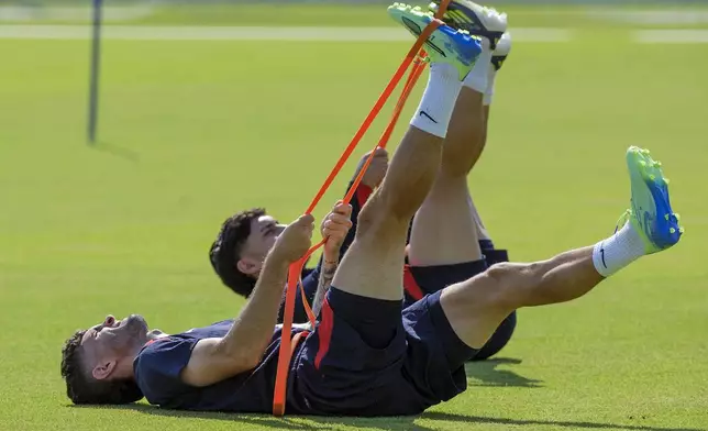 United States' Christian Pulisic, front, stretches with the team before practice, Friday, Oct. 11, 2024, in Austin, Texas, as the U.S. men's national soccer team prepares play Panama in an international friendly on Saturday. (AP Photo/Rodolfo Gonzalez)