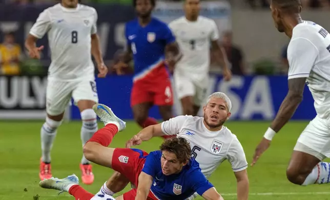 United States forward Brendon Aaronson, center front, is tackled by Panama midfielder Abidel Ayarza (5) during the first half of an international friendly soccer match, Saturday, Oct. 12, 2024, in Austin, Texas. (AP Photo/Rodolfo Gonzalez)