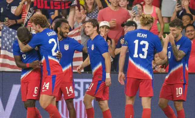 United States midfielder Yunus Musah (6), left, celebrates with forward Josh Sargent (24) and teammates after scoring against Panama during the second half of an international friendly soccer match, Saturday, Oct. 12, 2024, in Austin, Texas. (AP Photo/Rodolfo Gonzalez)