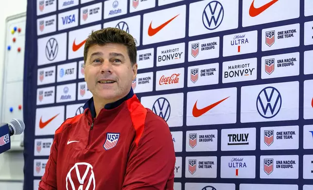 United States head coach, Mauricio Pochettino, takes a seat before speaking to the media, Friday, Oct. 11, 2024, in Austin, Texas, as the U.S. national men's soccer team prepares play Panama in an international friendly on Saturday. (AP Photo/Rodolfo Gonzalez)