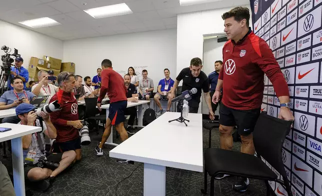 United States head coach, Mauricio Pochettino, takes a seat before speaking to the media, Friday, Oct. 11, 2024, in Austin, Texas, as the U.S. national men's soccer team prepares play Panama in an international friendly on Saturday. (AP Photo/Rodolfo Gonzalez)