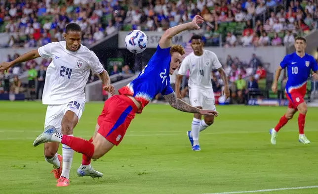 United States forward Josh Sargent (24) goes down after a tackle by Panama defender Edgardo Farina (24) during the first half of an international friendly soccer match, Saturday, Oct. 12, 2024, in Austin, Texas. (AP Photo/Rodolfo Gonzalez)