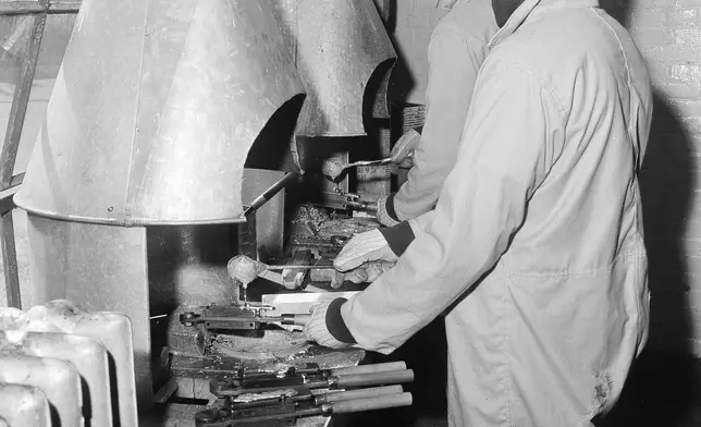 FILE - People incarcerated at the maximum security Holmesburg Prison in Philadelphia, turn out bullets for police revolvers, April 16, 1957. (AP Photo/Bill Ingraham, File)