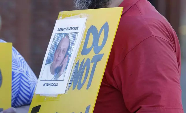 Thomas Roberson, older brother of condemned prisoner Robert Roberson, protests with others outside the prison where Roberson is scheduled for execution at the Huntsville Unit of the Texas State Penitentiary, Thursday, Oct. 17, 2024, in Huntsville, Texas. (AP Photo/Michael Wyke)