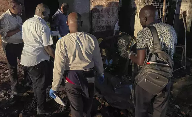 Uganda forensic officials inspect the site where a fuel truck exploded, on the outskirts of Kampala, Uganda, Tuesday, Oct. 22, 2024. (AP Photo)