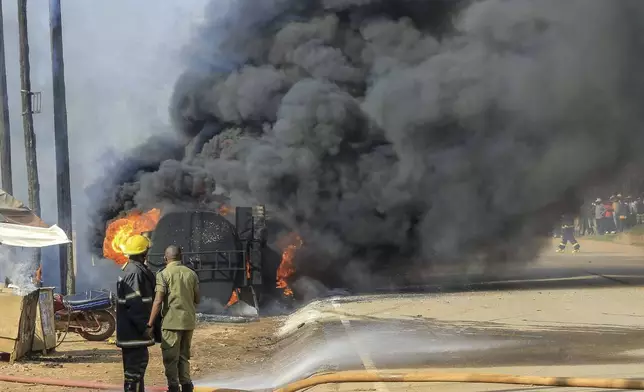 Firefighters try to contain a fire after a fuel truck exploded next to a highway on the outskirts of Kampala, Uganda, Tuesday, Oct. 22, 2024. (AP Photo)