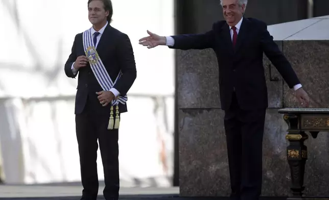 FILE - Uruguay's President Luis Lacalle Pou smiles after receiving the presidential sash from outgoing President Tabare Vazquez, in Montevideo, Uruguay, March 1, 2020. (AP Photo/Matilde Campodonico, File)