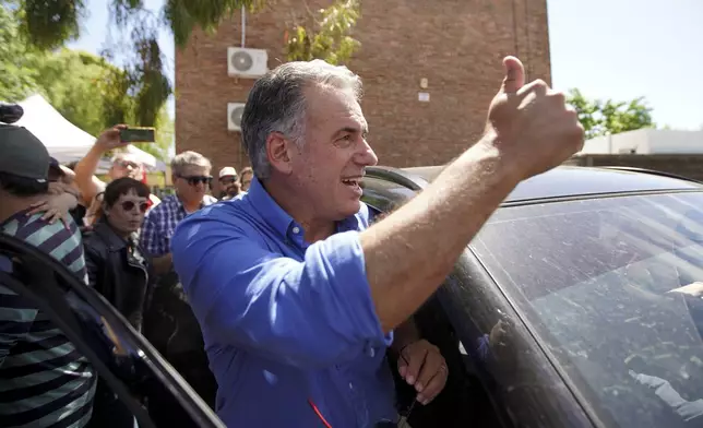 Frente Amplio presidential candidate Yamandu Orsi gets into a car after voting during general elections in Canelones, Uruguay, Sunday, Oct. 27, 2024. (AP Photo/Matilde Campodonico)