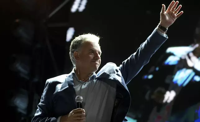 Frente Amplio presidential candidate Yamandu Orsi waves to supporters during a rally five days ahead of elections in Montevideo, Uruguay, Tuesday, Oct. 22, 2024. (AP Photo/Matilde Campodonico)