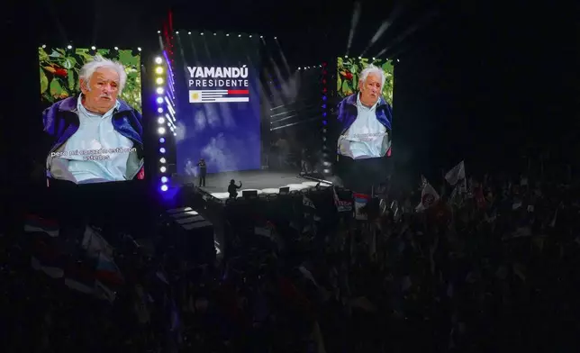 A screen shows former President Jose Mujica delivering a message during a rally for Frente Amplio presidential candidate Yamandu Orsi five days ahead of elections in Montevideo, Uruguay, Tuesday, Oct. 22, 2024. (AP Photo/Matilde Campodonico)