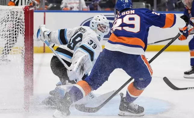 Utah Hockey Club goaltender Connor Ingram (39) stops a shot by New York Islanders' Brock Nelson (29) during the second period of an NHL hockey game, Thursday, Oct. 10, 2024, in Elmont, N.Y. (AP Photo/Frank Franklin II)