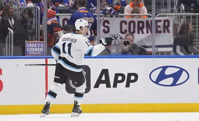 Utah Hockey Club's Dylan Guenther (11) celebrates after scoring the game winning goal during the overtime period of an NHL hockey game against the New York Islanders Thursday, Oct. 10, 2024, in Elmont, N.Y. (AP Photo/Frank Franklin II)