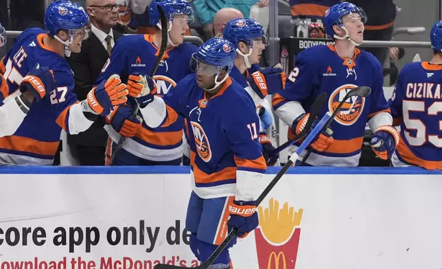 New York Islanders' Anthony Duclair (11) celebrates with teammates after scoring a goal during the first period of an NHL hockey game against the Utah Hockey Club, Thursday, Oct. 10, 2024, in Elmont, N.Y. (AP Photo/Frank Franklin II)