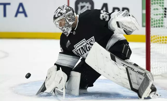 Los Angeles Kings goaltender Darcy Kuemper (35) blocks a shot during the first period of an NHL hockey game against the Utah Hockey Club, Saturday, Oct. 26, 2024, in Los Angeles. (AP Photo/Kyusung Gong)