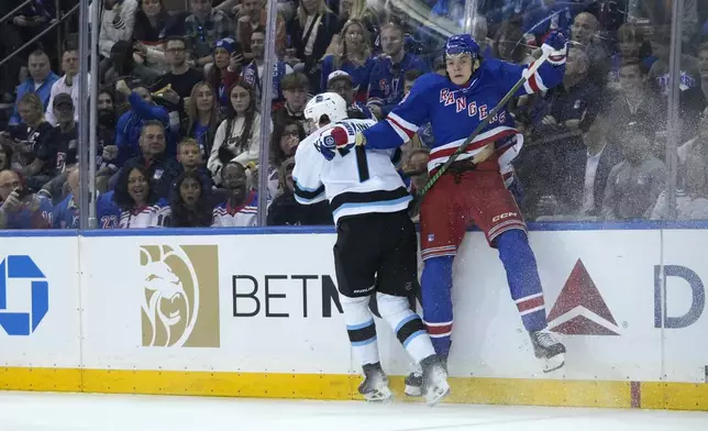 Utah Hockey Club's Michael Kesselring, left, collides with New York Rangers' Matt Rempe, right, while pursuing the puck during the first period of an NHL hockey game, Saturday, Oct. 12, 2024, in New York. (AP Photo/Pamela Smith)