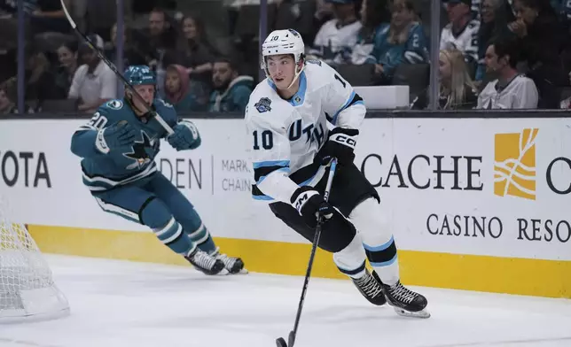 Utah Hockey Club defenseman Maveric Lamoureux (10) looks to pass during the first period of a pre-season NHL hockey game against the San Jose Sharks, Tuesday, Oct. 1, 2024, in San Jose, Calif. (AP Photo/Godofredo A. Vásquez)