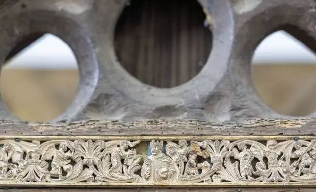 A carved ivory bas relief showing the coronation of Charles the Bald adorns a wooden throne that tradition claims belonged to the Apostle Saint Peter, the leader of the Early Christians in Rome and first Pope, and which he used as Bishop of Rome is shown, Tuesday, Oct. 8, 2024, in the room where it is temporarily kept in St. Peter's Basilica at The Vatican while Gian Lorenzo Bernini's Altar of the Seat in the Basilica is undergoing restoration together with Bernini's canopy over the papal altar. (AP Photo/Domenico Stinellis)