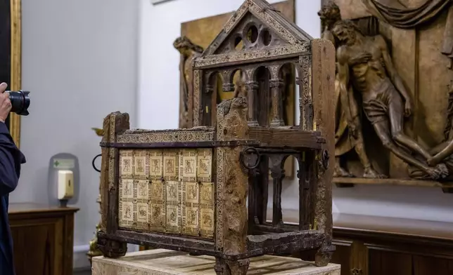 A wooden throne that tradition claims belonged to the Apostle Saint Peter, the leader of the Early Christians in Rome and first Pope, and which he used as Bishop of Rome is shown, Tuesday, Oct. 8, 2024, in the room where it is temporary kept in St. Peter's Basilica at The Vatican while Gian Lorenzo Bernini's Altar of the Seat in the Basilica is undergoing restoration together with Bernini's canopy over the papal altar. (AP Photo/Domenico Stinellis)