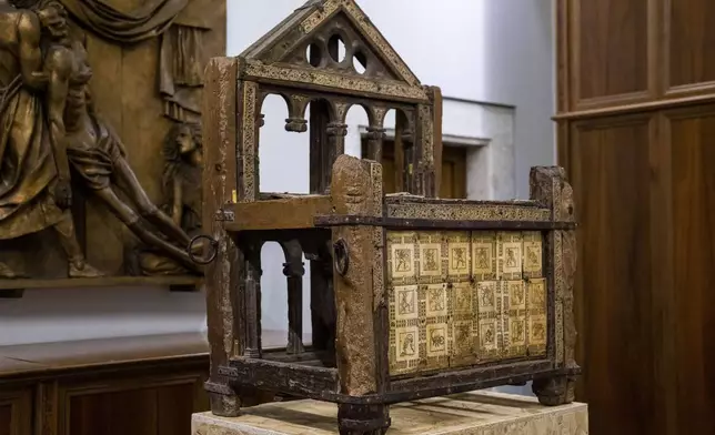 A wooden throne that tradition claims belonged to the Apostle Saint Peter, the leader of the Early Christians in Rome and their first Pope, and which he used as Bishop of Rome is shown, Tuesday, Oct. 8, 2024, in the room where it is temporarily kept in St. Peter's Basilica at The Vatican while Gian Lorenzo Bernini's Altar of the Seat in the Basilica is undergoing restoration, together with Bernini's canopy over the papal altar. (AP Photo/Domenico Stinellis)