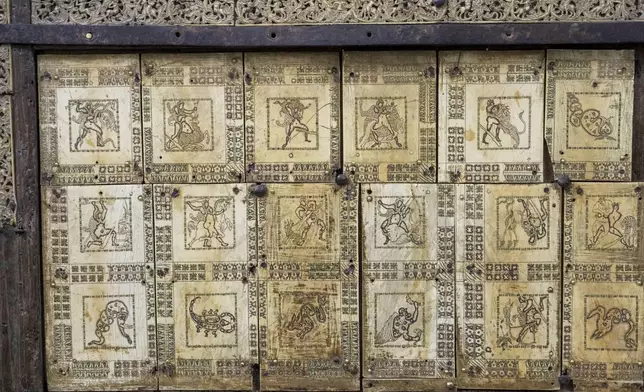 Plaques showing the Labours of Hercules and some of the zodiac constellations adorn a wooden throne that tradition claims belonged to the Apostle Saint Peter, the leader of the Early Christians in Rome and first Pope, and which he used as Bishop of Rome is shown, Tuesday, Oct. 8, 2024, in the room where it is temporary kept in St. Peter's Basilica at The Vatican while Gian Lorenzo Bernini's Altar of the Seat in the Basilica is undergoing restoration together with Bernini's canopy over the papal altar. (AP Photo/Domenico Stinellis)