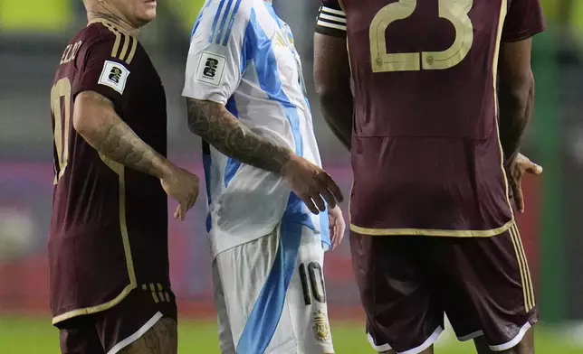 Argentina's Lionel Messi argues with Venezuela's Jose Rondon during a FIFA World Cup 2026 qualifying soccer match in Maturin, Venezuela, Thursday, Oct. 10, 2024. (AP Photo/Ariana Cubillos)