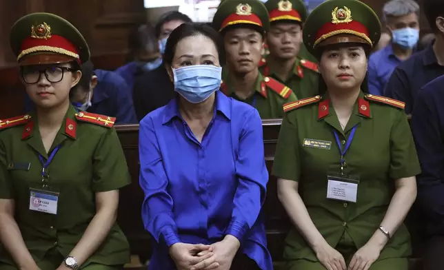 Vietnamese real estate tycoon Truong My Lan, center, sits in court to wait for her verdict on fraud, money laundering and illegal cross-border money transferring in Ho Chi Minh city, Vietnam Thursday, Oct. 17, 2024. (Quynh Tran/VnExpress via AP)