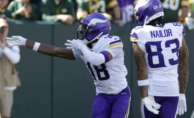 Minnesota Vikings wide receiver Justin Jefferson (18) celebrates a touchdown during the first half of an NFL football game against the Green Bay Packers, Sunday, Sept. 29, 2024, in Green Bay, Wis. (AP Photo/Matt Ludtke)