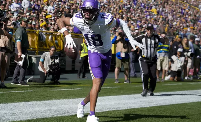 Minnesota Vikings wide receiver Justin Jefferson (18) celebrates a touchdown during the first half of an NFL football game against the Green Bay Packers, Sunday, Sept. 29, 2024, in Green Bay, Wis. (AP Photo/Morry Gash)