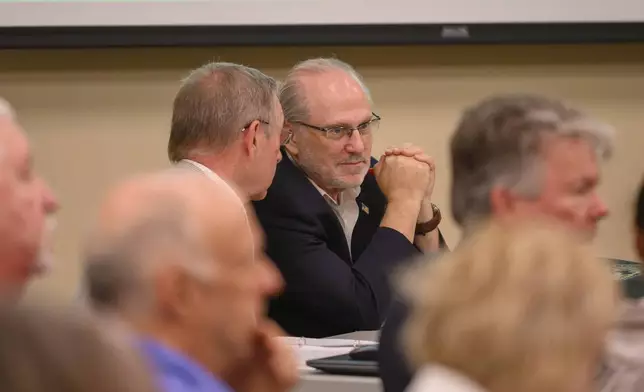 Challenger Steven Bartelski and EagleAI CEO Rick Richards present challenges to the Forsyth election board concerning the eligibility of 800 voters at the Forsyth County Voter Registrar in Cumming, Ga., June 28, 2024. (Jamie Spaar /Atlanta Journal-Constitution via AP)