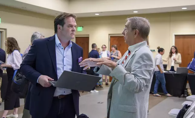 Steven Bartelski speaks with attendees about the challenges concerning the eligibility of 800 voters at the Forsyth County Voter Registrar in Cumming, Ga., June 28, 2024. (Jamie Spaar/Atlanta Journal-Constitution via AP)