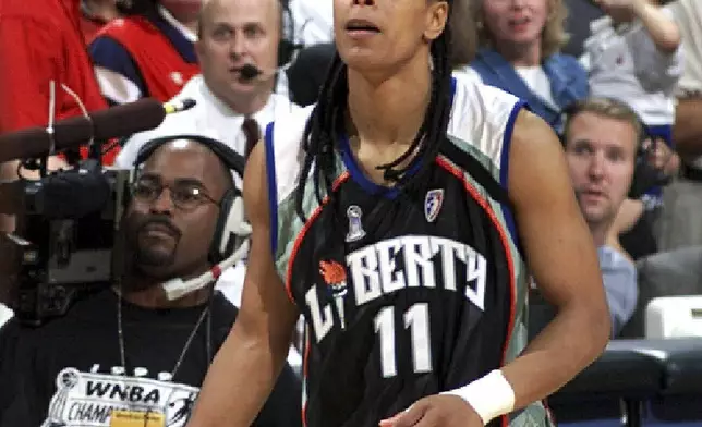 FILE - New York Liberty's Teresa Weatherspoon (11) watches her shot from beyond midcourt go in at the buzzer to defeat the Houston Comets in Game 2 of the WNBA basketball finals Sept. 4, 1999, in Houston. (AP Photo/David J. Phillip, File)