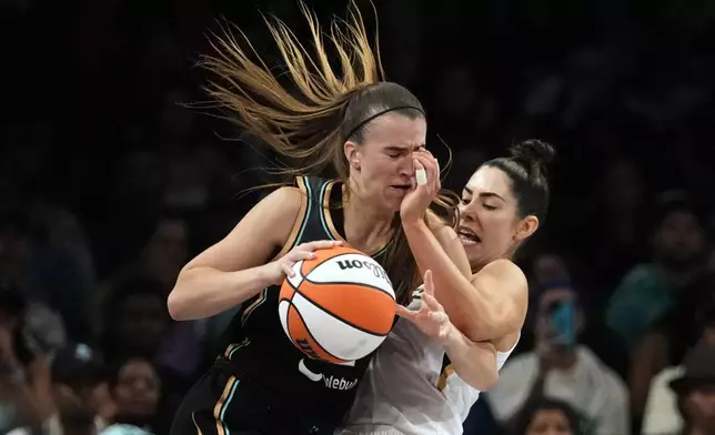 FILE - Las Vegas Aces' Kelsey Plum, right, defends New York Liberty's Sabrina Ionescu during the second half in Game 4 of a WNBA basketball final playoff series, Oct. 18, 2023, in New York. (AP Photo/Frank Franklin II, File)