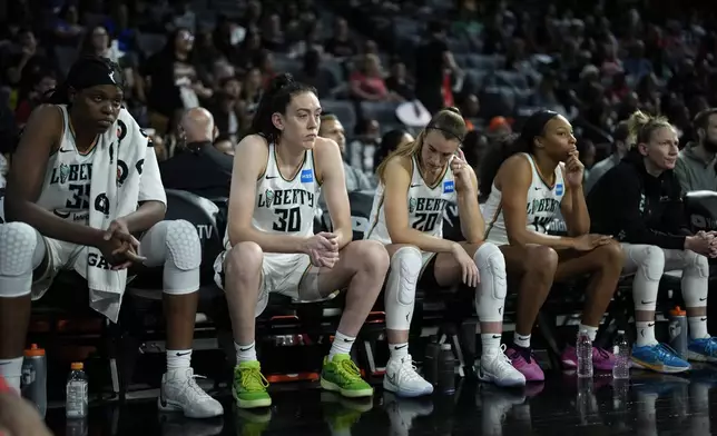 FILE - New York Liberty players sit on the bench as they trail the Las Vegas Aces in the final minute during the second half in Game 2 of a WNBA basketball final playoff series, Oct. 11, 2023, in Las Vegas. (AP Photo/John Locher, File)