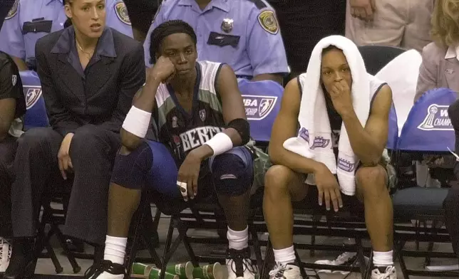 FILE - New York Liberty's Rebecca Lobo, left, Tari Phillips, center, and Teresa Weatherspoon watch from the bench in the final seconds against the Houston Comets in Game 2 of the WNBA Championship game, Aug. 26, 2000, in Houston. (AP Photo/Pat Sullivan, File)