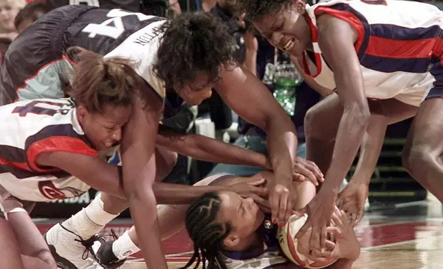 FILE - New York Liberty's Teresa Weatherspoon, bottom, and Kym Hampton battle against Houston Comets Cynthia Cooper and Sheryl Swoopes for a loose ball during the first half in Game 3 of the WNBA Finals, Sept. 5, 1999, in Houston. (AP Photo/David J. Phillip, File)