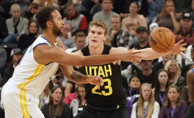 Utah Jazz forward Lauri Markkanen (23) defends against Golden State Warriors forward Kyle Anderson, left, in the first half of an NBA basketball game Friday, Oct. 25, 2024, in Salt Lake City. (AP Photo/George Frey)