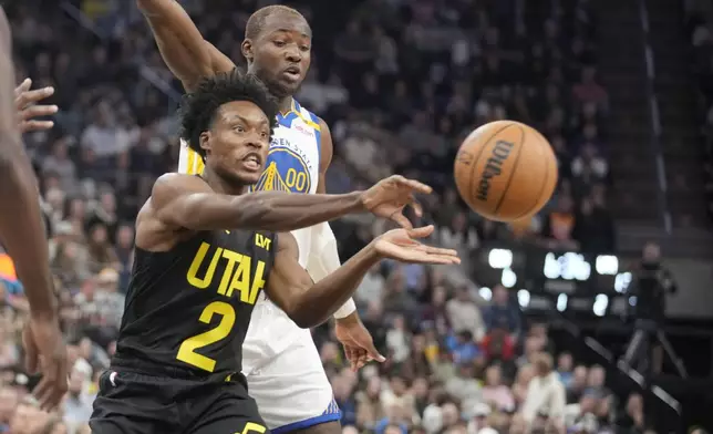 Utah Jazz guard Collin Sexton (2) passes the ball as Golden State Warriors forward Jonathan Kuminga (00) defends in the first half of an NBA basketball game Friday, Oct. 25, 2024, in Salt Lake City. (AP Photo/George Frey)