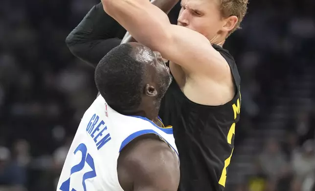 Utah Jazz forward Lauri Markkanen, right, is defended by Golden State Warriors forward Draymond Green (23) in the first half of an NBA basketball game Friday, Oct. 25, 2024, in Salt Lake City. (AP Photo/George Frey)