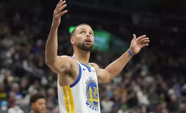 Golden State Warriors guard Stephen Curry looks at a replay after being called for a foul in the first half of an NBA basketball game against the Utah Jazz, Friday, Oct. 25, 2024, in Salt Lake City. (AP Photo/George Frey)