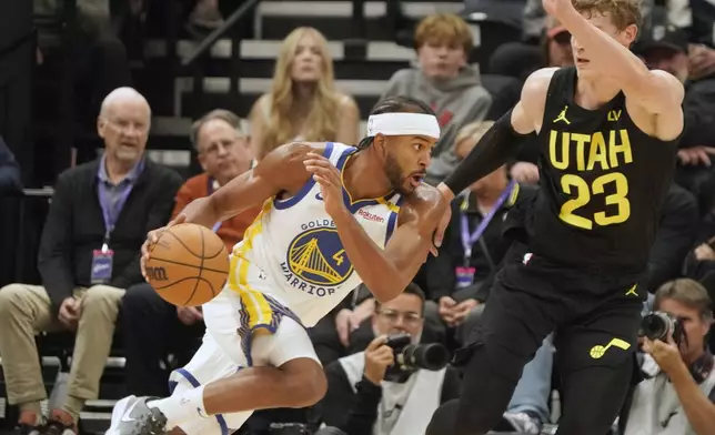 Golden State Warriors guard Moses Moody (4) drives against Utah Jazz forward Lauri Markkanen (23) in the first half of an NBA basketball game Friday, Oct. 25, 2024, in Salt Lake City. (AP Photo/George Frey)