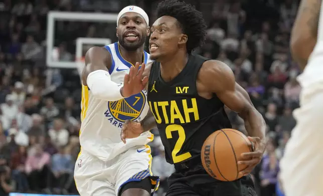 Utah Jazz guard Collin Sexton (2) drives to the basket as Golden State Warriors guard Buddy Hield (7) defends in the first half of an NBA basketball game Friday, Oct. 25, 2024, in Salt Lake City. (AP Photo/George Frey)