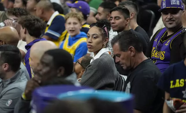 Dearica Hamby of the Los Angeles Sparks watches a NBA preseason basketball game between the Los Angeles Lakers and the Golden State Warriors, Tuesday, Oct. 15, 2024, in Las Vegas. (AP Photo/John Locher)