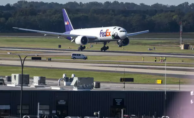 A FedEx cargo plane arrives at Dulles International Airport carrying giant pandas from China on Tuesday, Oct. 15, 2024 in Sterling, Va. (AP Photo/Kevin Wolf)