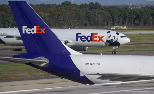 A FedEx cargo plane arrives at Dulles International Airport carrying giant pandas from China on Tuesday, Oct. 15, 2024 in Sterling, Va. (AP Photo/Kevin Wolf)